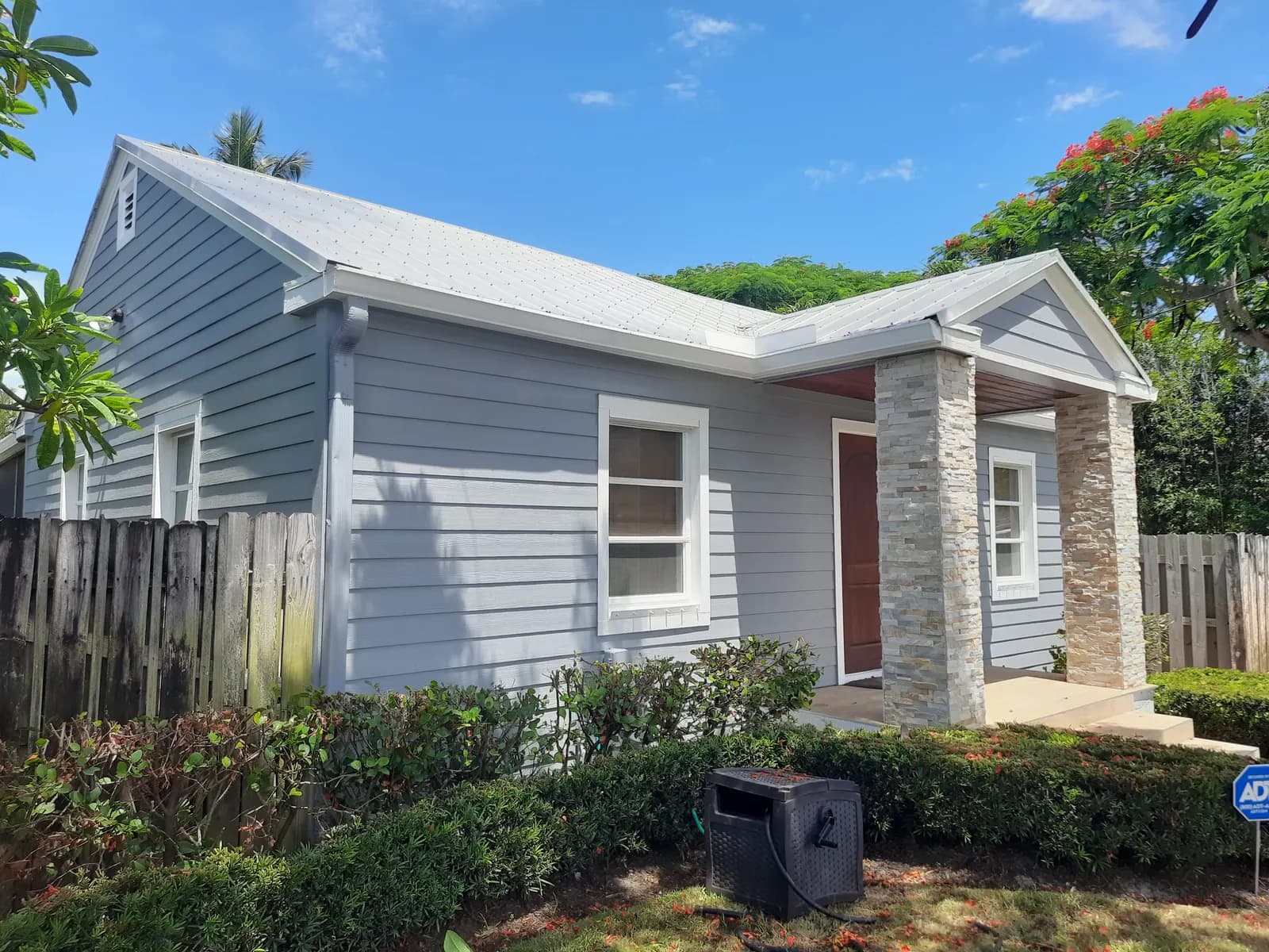 Delray Beach cottage repainted gray-blue with white trim and stone-clad columns