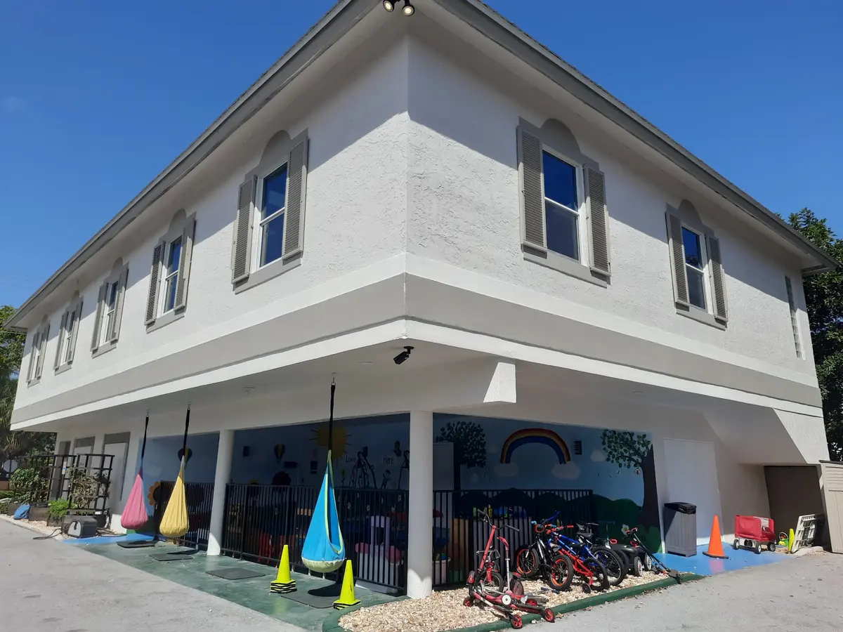 Two-story school building in Boca Raton repainted white with gray window surrounds