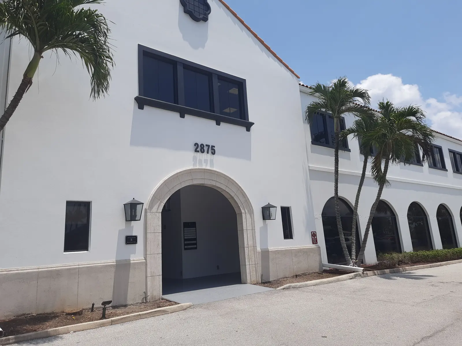 The same Palm Beach entry repainted bright white with dark bronze window frames