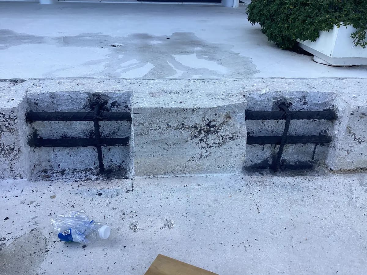 Two repair pockets in a concrete ledge, the rebar cleaned and coated