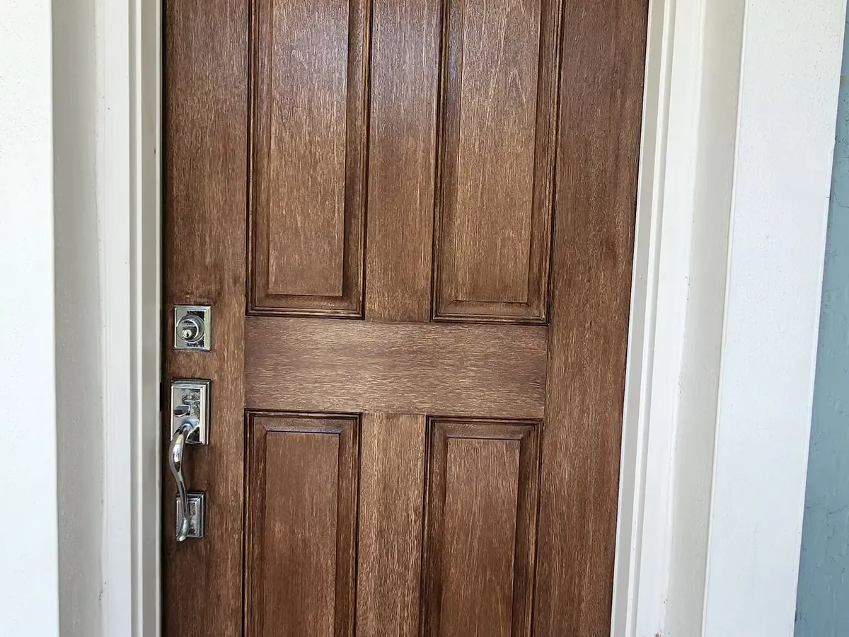 Six-panel front door in Jupiter stained a rich medium brown